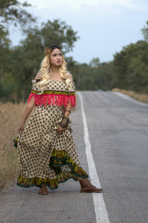beautiful young girl in a field in vintage fashion styleの写真素材