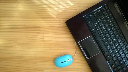 laptop on wood tableの写真素材