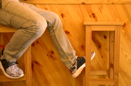 leg of teen hipster and wood counter backgroundの写真素材