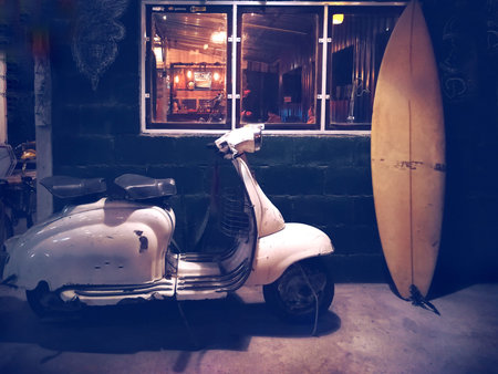 motorbike and surf board parking outside The bar near windows