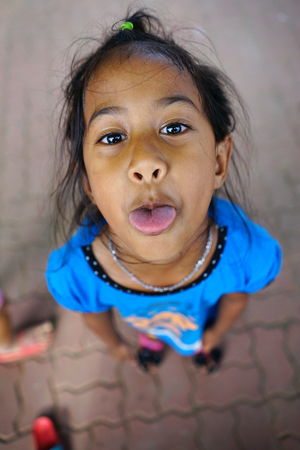 Singburi Thailand , 05  5  2018 : Thailand countryside kids  tongue  to the tourist  take a picture  they   at Wat Ranam church , Singburi Thailandのeditorial素材