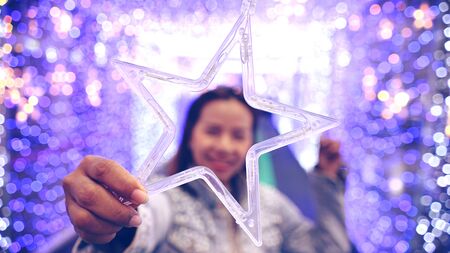 happy emotion. model women peeps through Led flash star shapeの写真素材