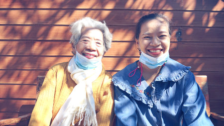 Pet Cha boon ,Thailand , Two  woman smiling brightly In the midst of the coronavirus(covid-19). they were wearing face masks. When they going outのeditorial素材
