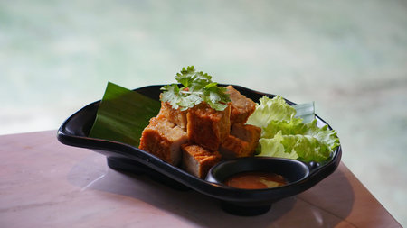 Fried Tofu or Tofu with sauce in black plate