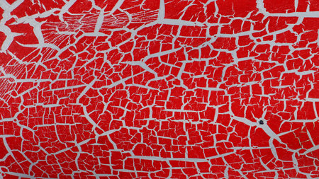 abstract background of cracked paint on a red wall, close-up