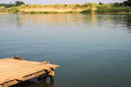 Wooden pier beside a riverの写真素材