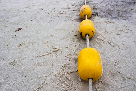 Yellow Buoy on Beachの写真素材