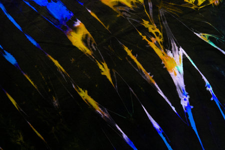 Yellow and Blue tie dye abstract texture, Colorful tie dye abstract pattern on black fabric...