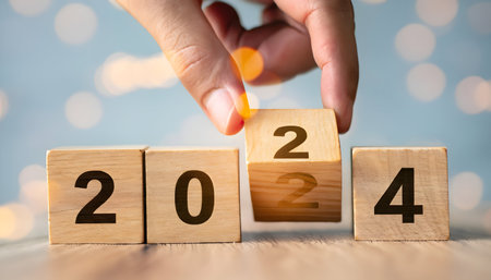 From 2023 to 2024. Merry Christmas and Happy New Year,  idea concept. Wood cubes or blocks on table, turn of year from 2023 to 2024.の素材