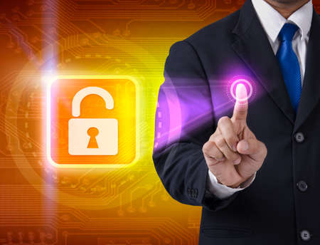 Hand pushing virtual security button on digital backgroundの写真素材