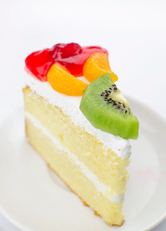 Piece of cake with fresh fruit isolated on white backgroundの写真素材