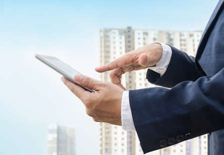Hands of a businessman holding digital tabletの写真素材