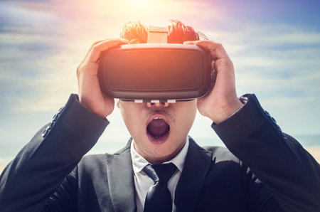 Businessman wearing virtual reality glasses . Mixed mediaの写真素材