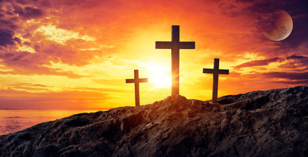 Silhouetted christian cross silhouette on the mountain at sunset