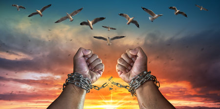 Hands in fists breaking a chain freedom. The concept of gaining freedom.