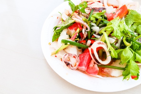 Total seafood salad on a plate. Plates made of foam. Whiteの写真素材