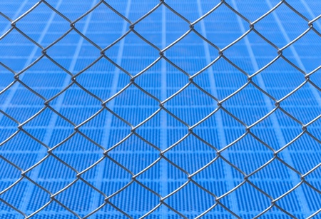 chainlink fence against Blue backgroundの写真素材