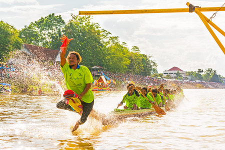 CHUMPHON, THAILAND-OCT 23  Unidentified rowers in Climbing Bows toward Snatching a Flag native Thai long boats compete during King s cup Native Long Boat Race Championship on Oct 23, 2013 in Chumphon, Thailand のeditorial素材