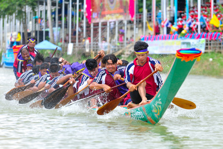 CHUMPHON, THAILAND-OCT 21  Unidentified rowers in Climbing Bows toward Snatching a Flag native Thai long boats compete during King s cup Native Long Boat Race Championship on Oct 21, 2013 in Chumphon, Thailand のeditorial素材