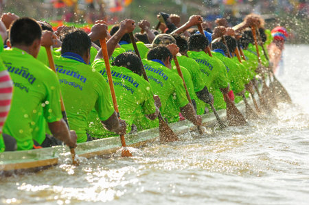 CHUMPHON, THAILAND-OCT 23  Unidentified rowers in Climbing Bows toward Snatching a Flag native Thai...