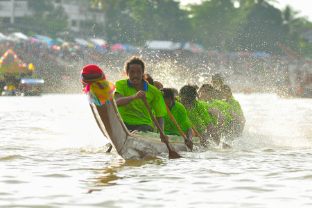 CHUMPHON, THAILAND-OCT 23  Unidentified rowers in Climbing Bows toward Snatching a Flag native Thai long boats compete during King s cup Native Long Boat Race Championship on Oct 23, 2013 in Chumphon, Thailand のeditorial素材