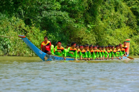 CHUMPHON, THAILAND-OCT 21  Unidentified rowers in Climbing Bows toward Snatching a Flag native Thai long boats compete during King s cup Native Long Boat Race Championship on Oct 21, 2013 in Chumphon, Thailand のeditorial素材