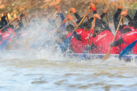 CHUMPHON, THAILAND-OCT 22  Unidentified rowers in Climbing Bows toward Snatching a Flag native Thai long boats compete during King s cup Native Long Boat Race Championship on Oct 22, 2013 in Chumphon, Thailand のeditorial素材