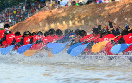 CHUMPHON, THAILAND-OCT 22  Unidentified rowers in Climbing Bows toward Snatching a Flag native Thai long boats compete during King s cup Native Long Boat Race Championship on Oct 22, 2013 in Chumphon, Thailand のeditorial素材
