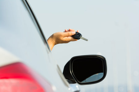 driver holding car keys driving
