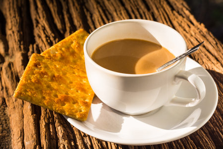 coffee cup and bread on wood