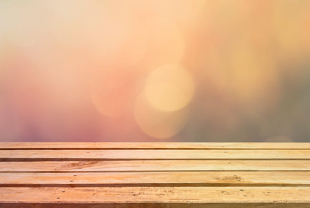 Empty wooden deck table on bokeh background with retro effect