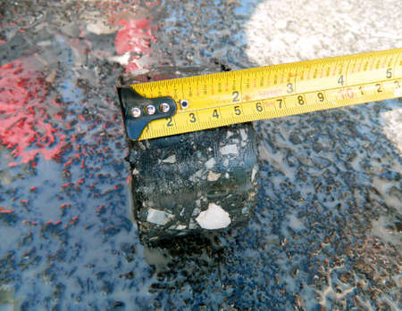 Asphalt pavement penetration asphalt to determine the thickness of the floor in the other work.の写真素材