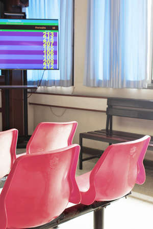 Red chair is waiting for the queue from the fire screen.の写真素材