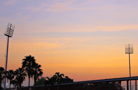Evening Stadium Red sky background with palm tree silhouette and two posters.の写真素材