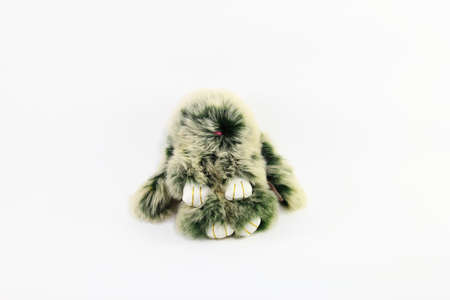 Gray rabbit doll with white hand on white backgroundの写真素材