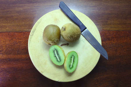 Kiwi cooked on a cutting board and knife.の写真素材