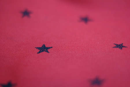 Red striped background with many black stars.の写真素材