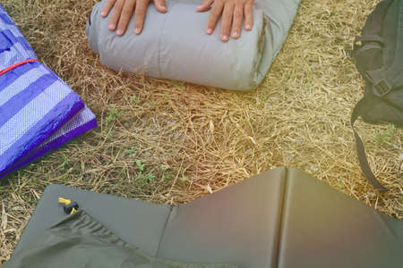 Camping equipment Sleeping bag People are rolls sleeping bags to store.のeditorial素材
