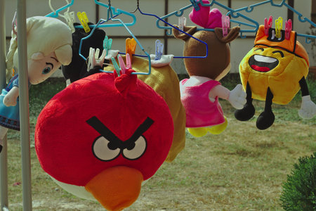 Many dolls hang in the sun with a clothesline.のeditorial素材