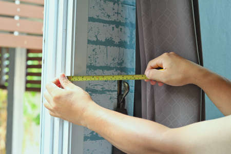 Measure the mounting distance of the curtain on the wallのeditorial素材