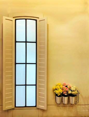 Real concrete wall and mock-up windows with the soft yellow light hand-painted pastel color, decorated with a flower pot in the hanger. The concept for wall display, and background with copy space.の写真素材