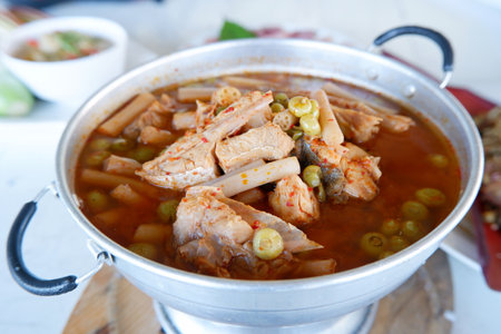 Kaeng Som is a sour and spicy fish curry or soup with vegetables popular in southern Thailand. The curry is characteristic of its sour taste, which comes from tamarind and served in a hot pot.の写真素材