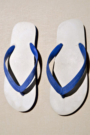 Men's slippers classic retro style made of rubber flip flops widely used in Thailand. Placed on the monotone plained background.の写真素材