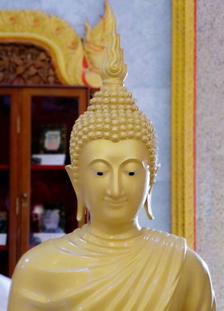 Golden Buddha statue illuminated sculpture of Thailand in the temple. Phuket, Thailand.の写真素材