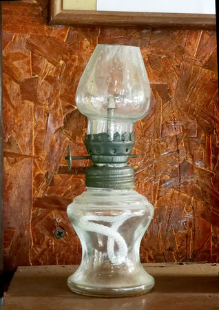 An antique lantern that uses kerosene as fuel, the wick is made of cotton rope.の写真素材