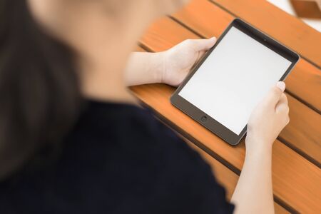 Digital tablet computer with isolated screen in female handsの写真素材
