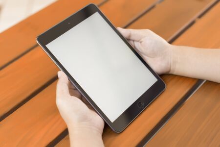 Digital tablet computer with isolated screen in female handsの写真素材
