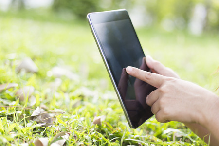 Woman Use Tablet for Relaxation at Playgroundの写真素材