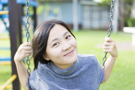 Woman Playing on the Swingsの写真素材