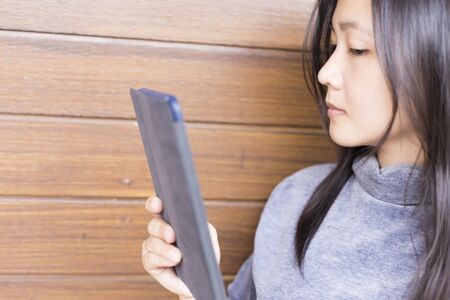 Woman Use Tablet for Relaxation: Close Upの写真素材